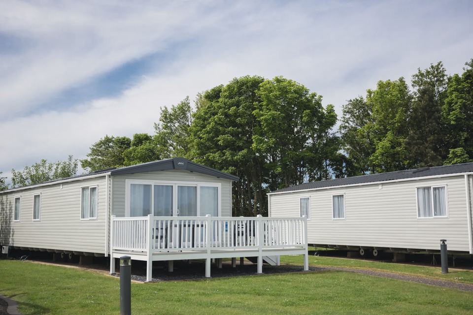 Static caravans with decking on the grass