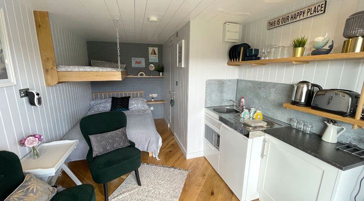 Cabin with bed and kitchen area