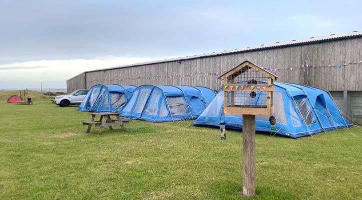 Tents pitched by the barn