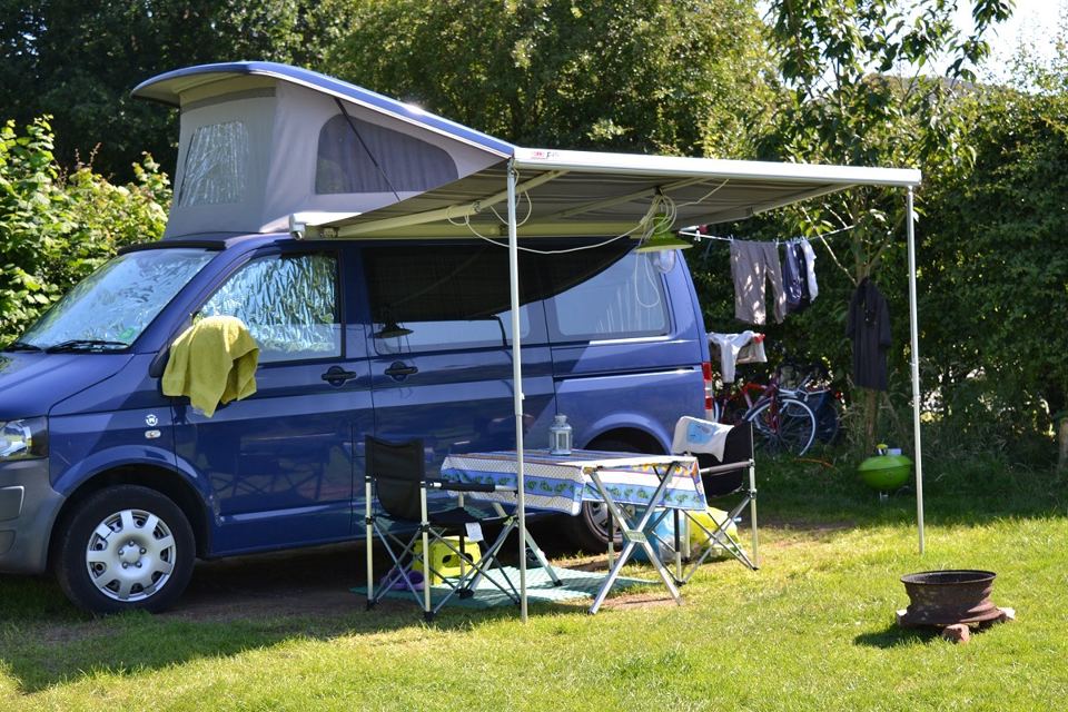Campervan with awning on the grass