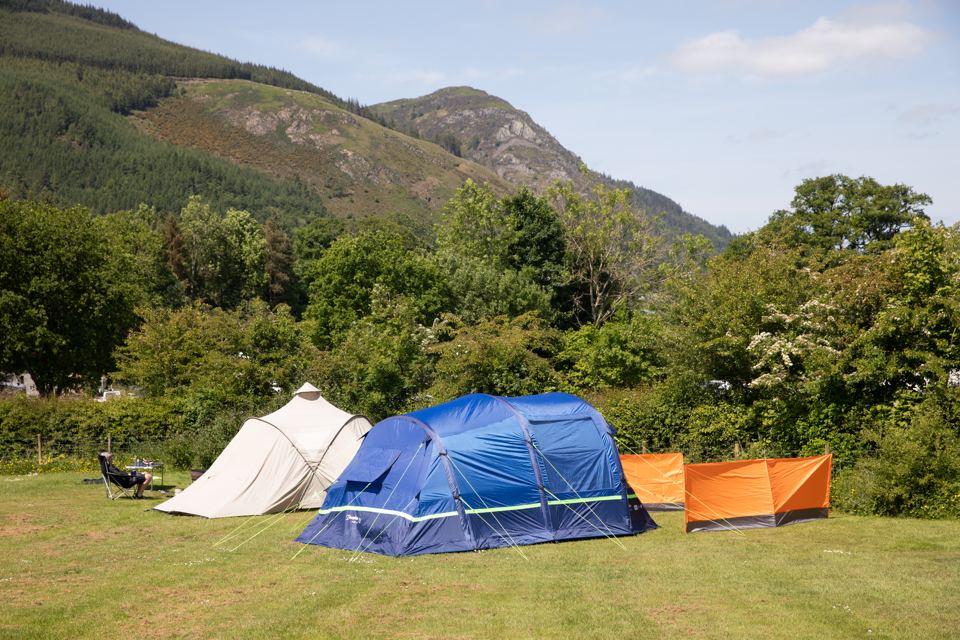 Tents pitched with hills behind