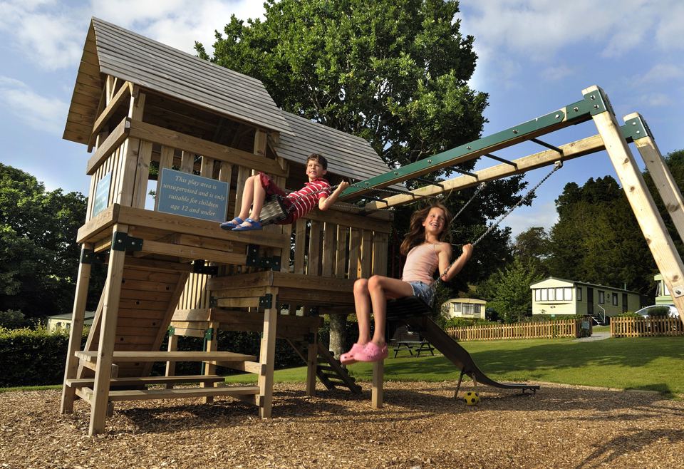 Wooden climbing frame and slide