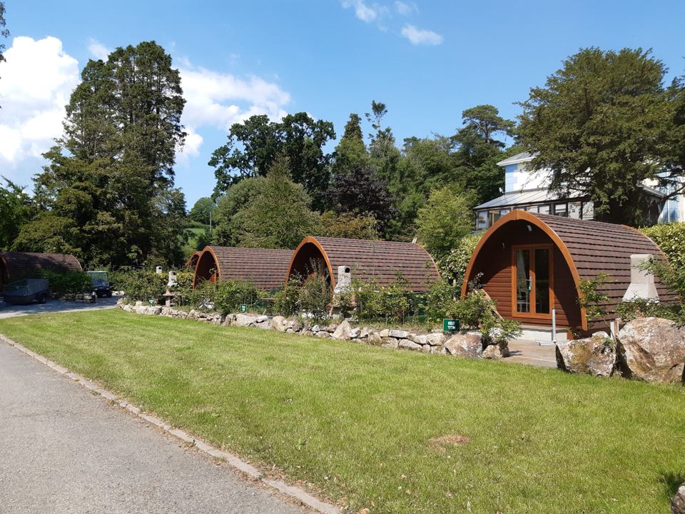 Wooden pods beside the drive