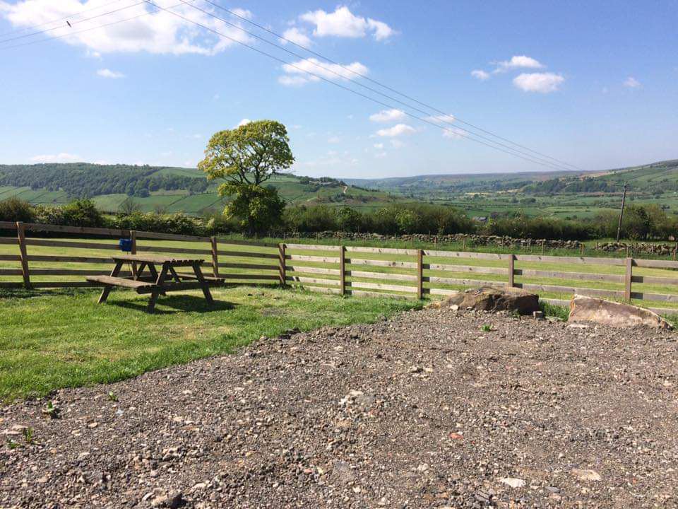 Picnic table and fence above the valley