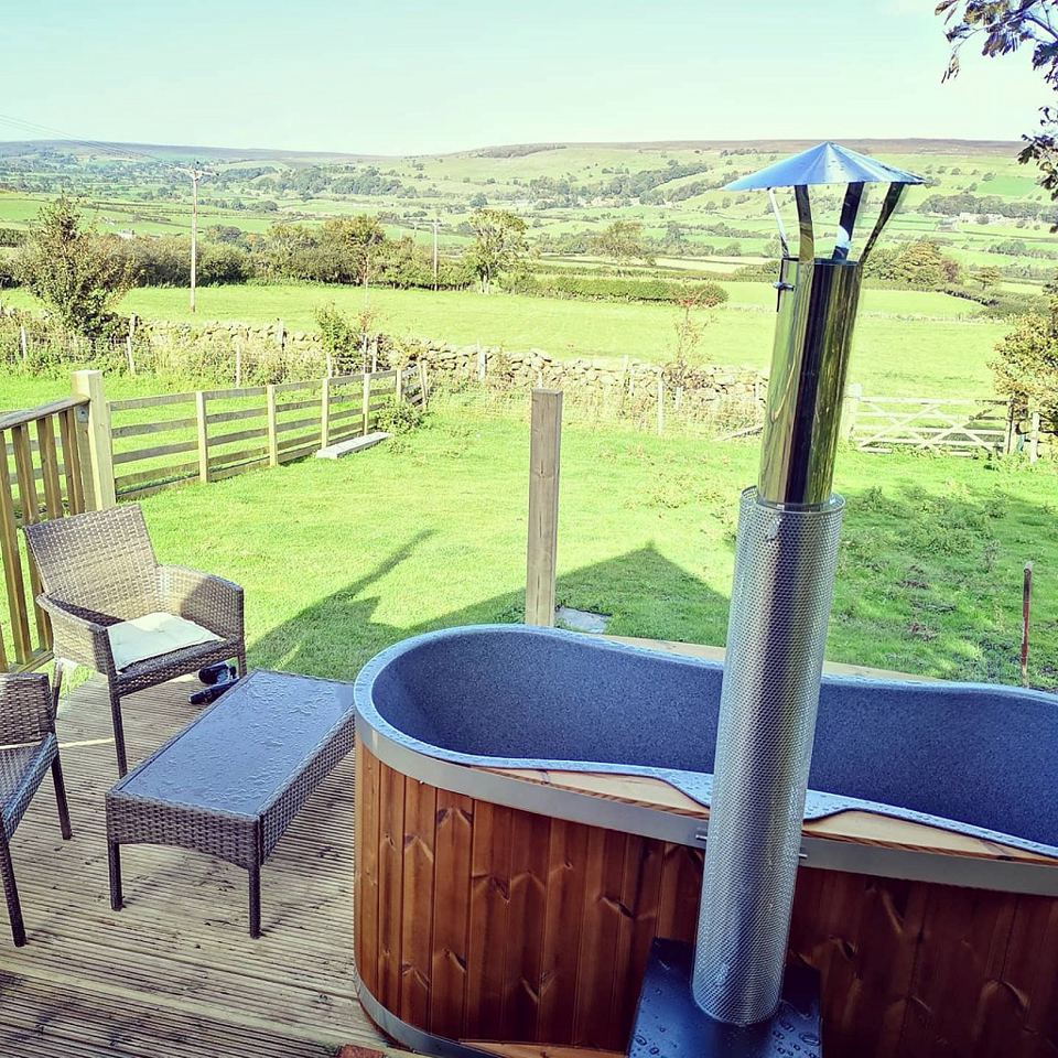 Wood-fired hot tub with valley view