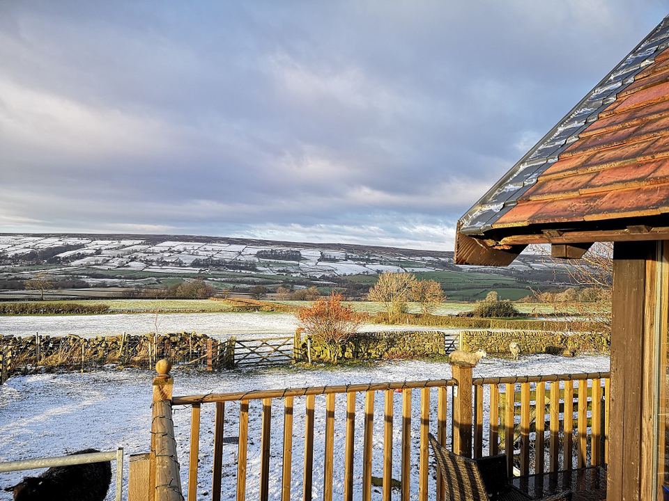 Cabin deck over the snowy valley