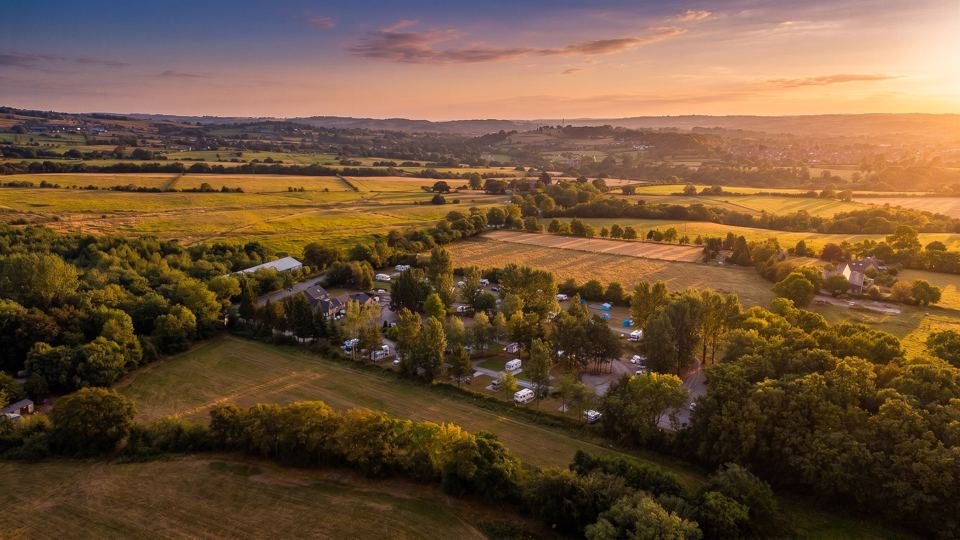 Site among fields and trees at sunset