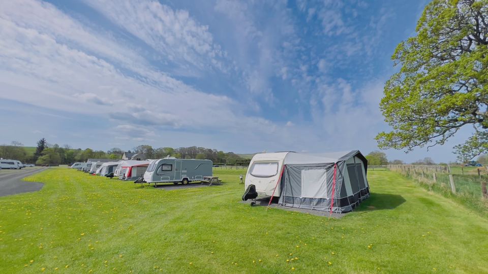 Caravan with awning on grass