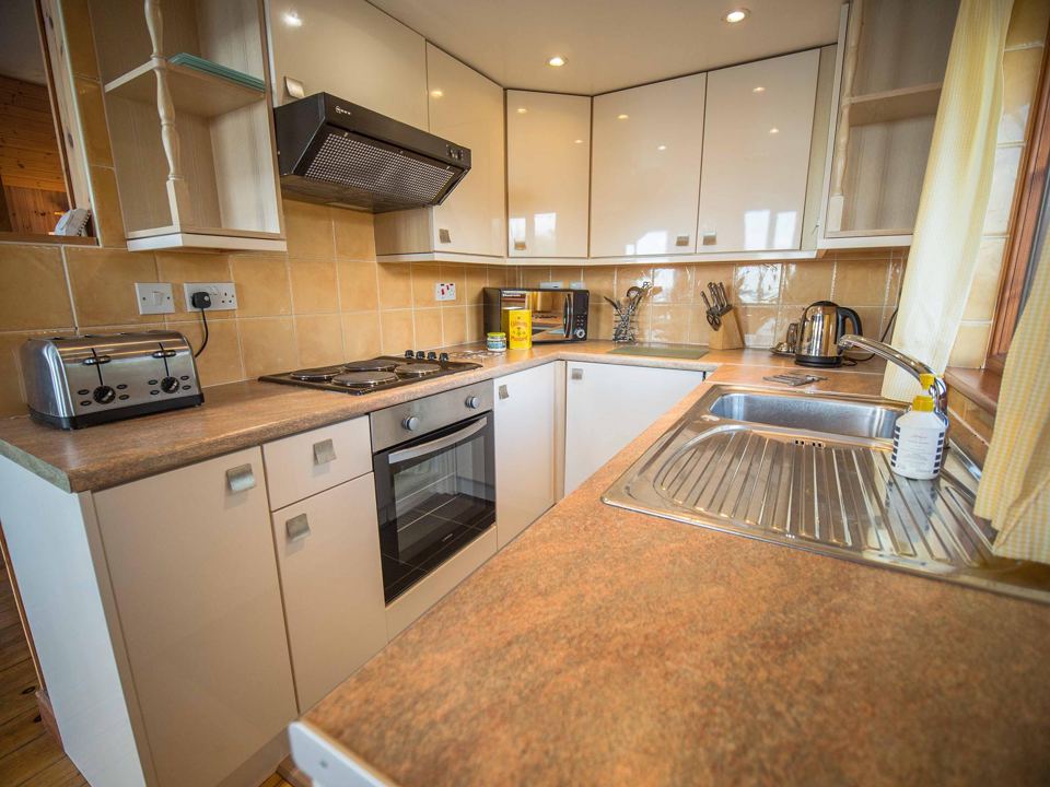 Kitchen with cooker and sink