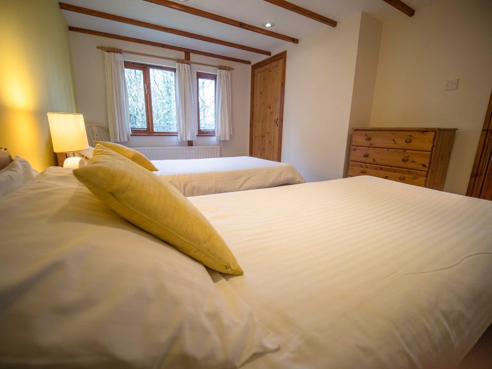 Twin bedroom with yellow cushions