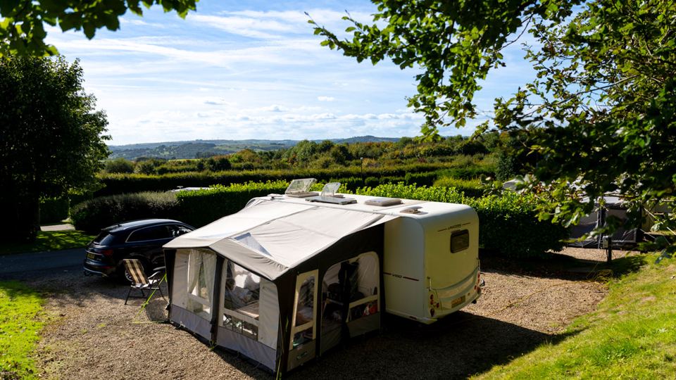 Caravan and awning under trees