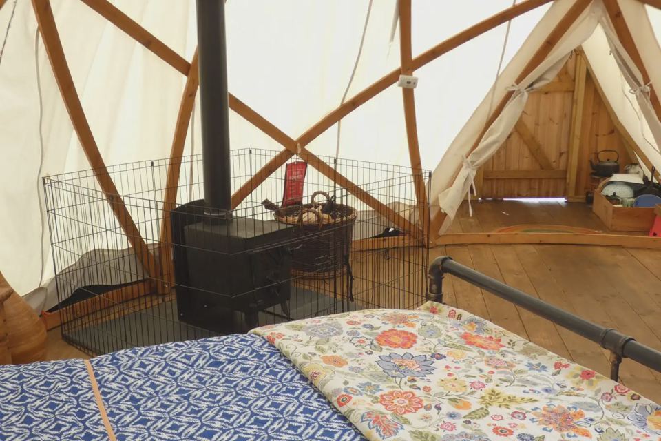Wood stove and bed in the dome