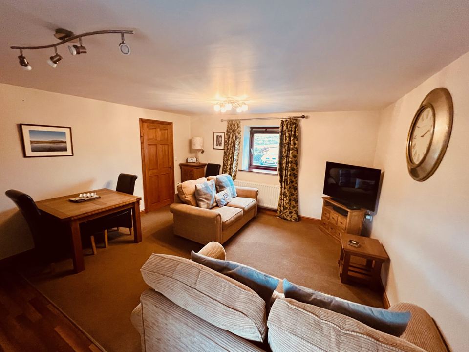 Lounge with TV and dining table