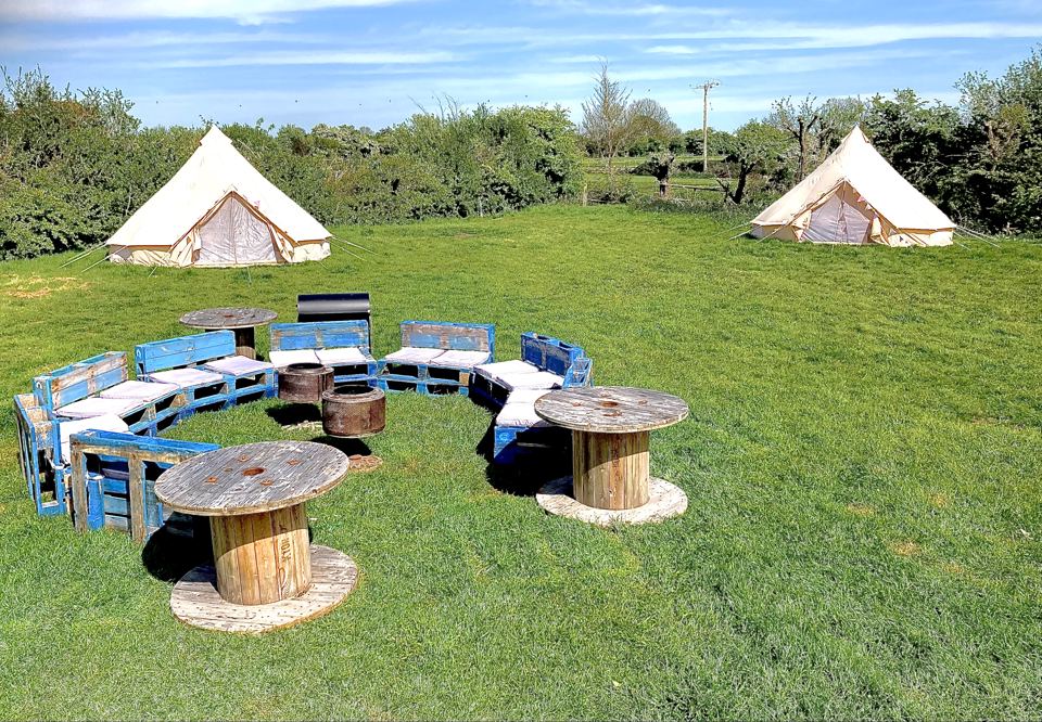 Bell tents and seating round a fire pit
