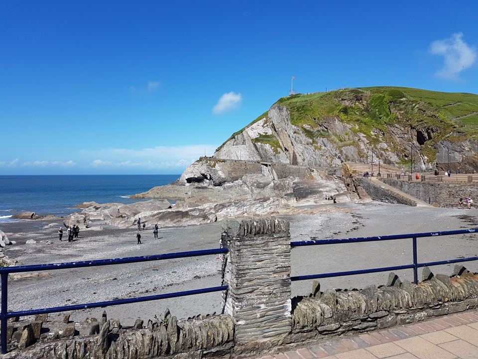 Beach and headland beyond railings