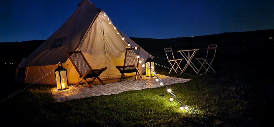 Bell tent lit up after dark
