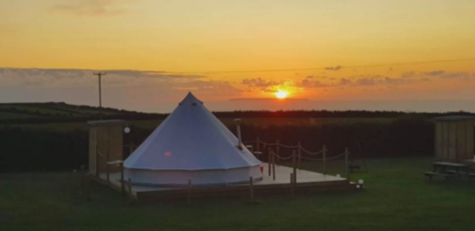 Bell tent on the grass at sunset