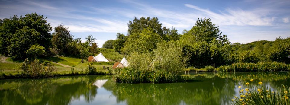 Bell tents beyond the water