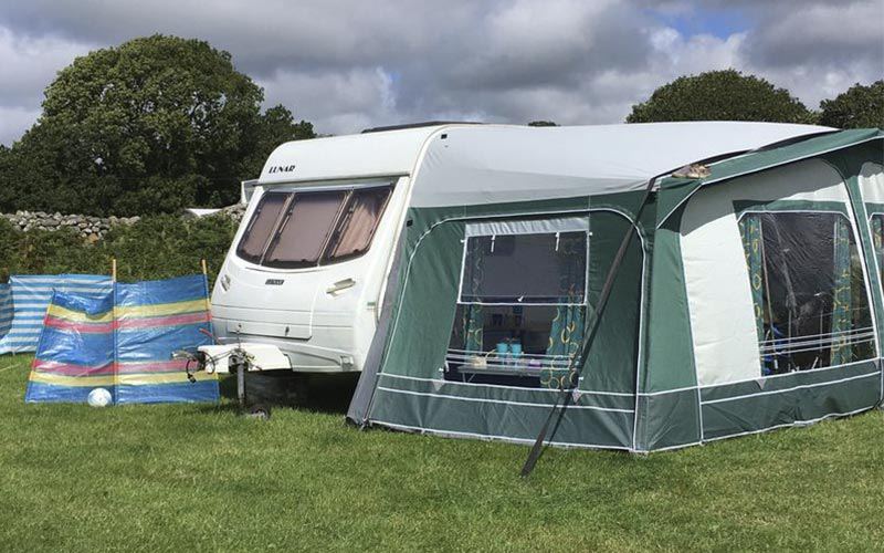 Caravan with awning on grass
