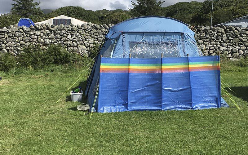 Tent by the stone wall