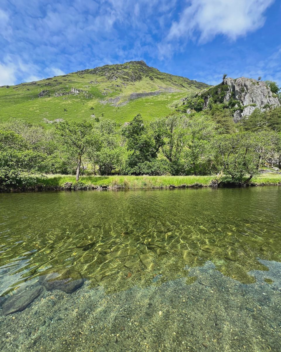 Clear river with hills behind