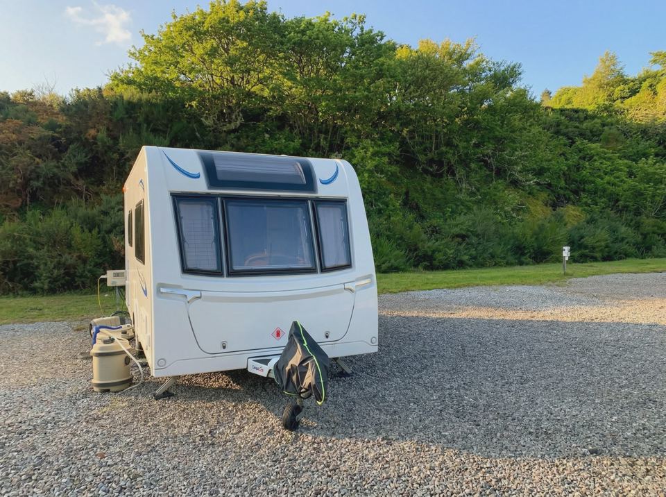Touring caravan on gravel pitch
