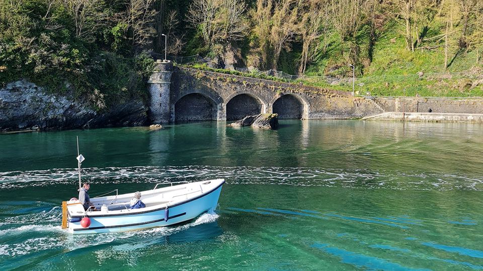 Boat on the estuary below the bridge