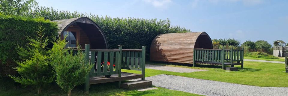 Camping pods beside the pitches