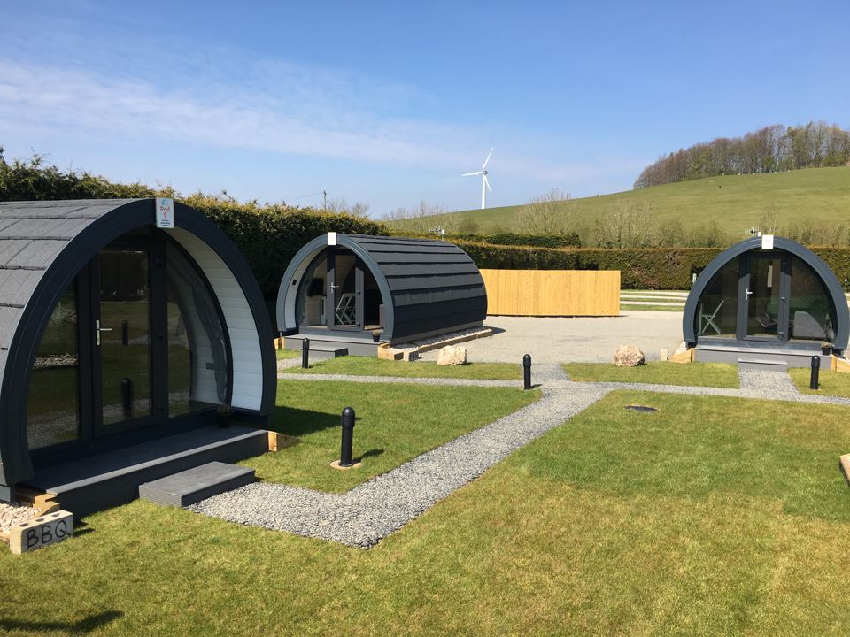 Glamping pods on gravel and grass