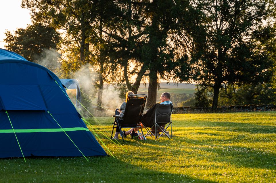 Tent with chairs under trees