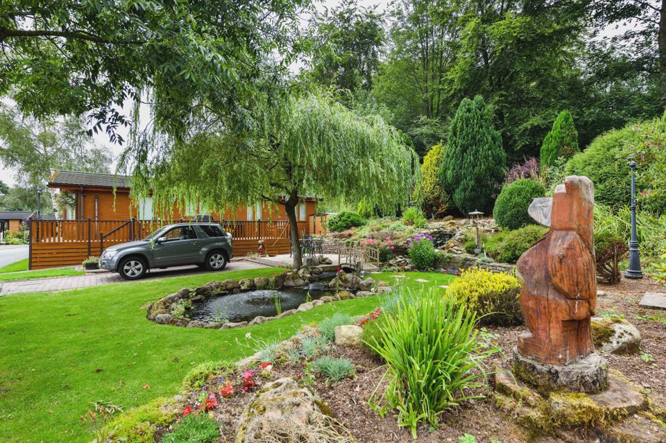 Garden with pond and carved statue