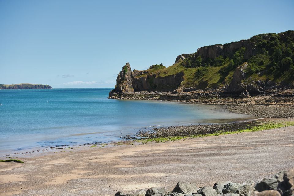 Sandy bay below the park