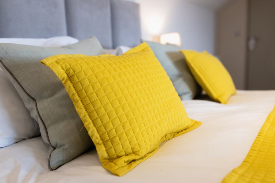 Bed with yellow cushions