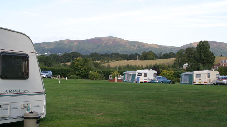 Caravan pitches below the hills