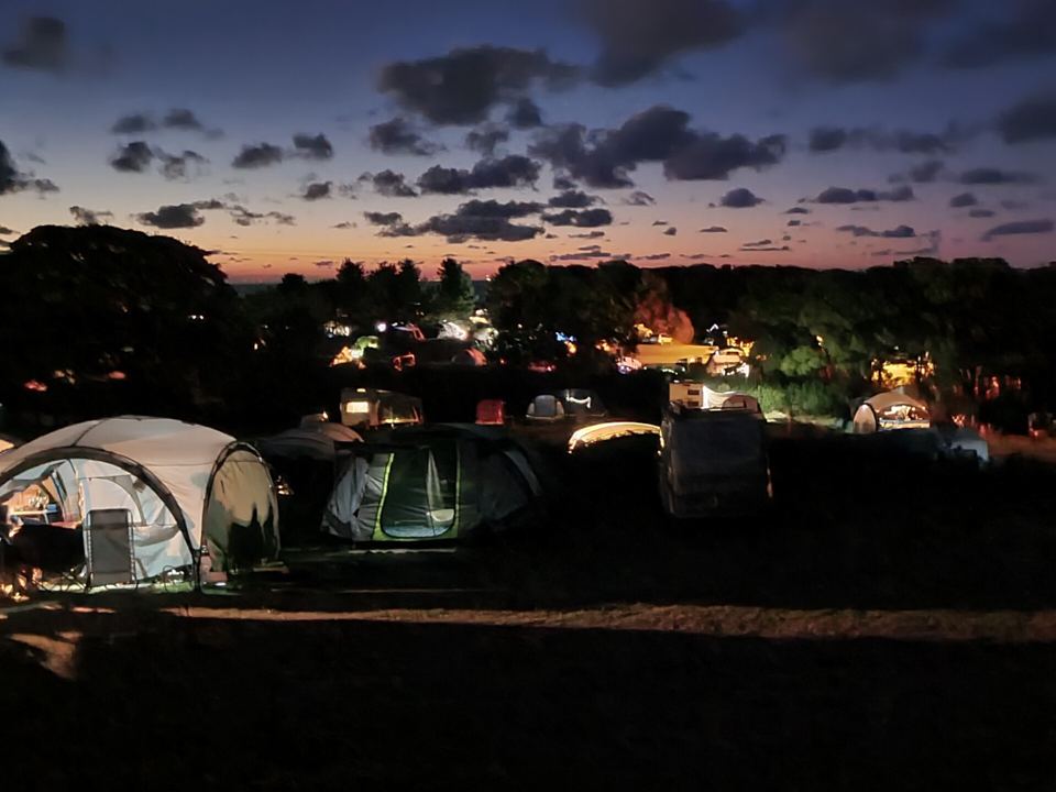 Tents lit up at dusk