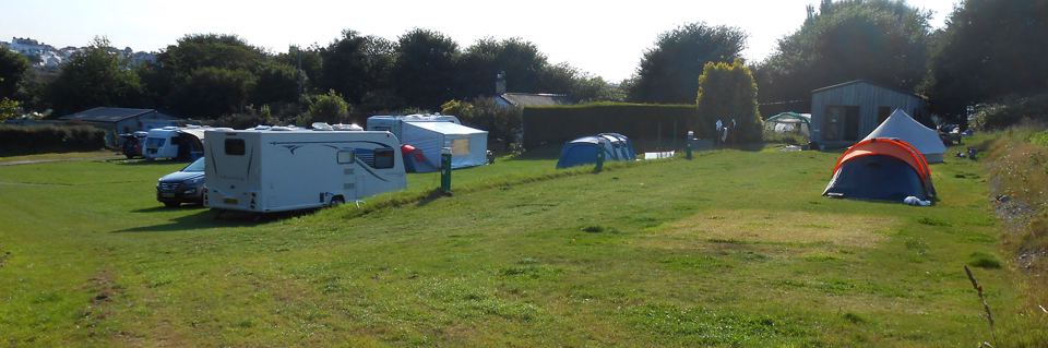 Motorhome and tent in the field