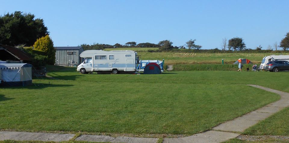 Motorhome and tents on the grass