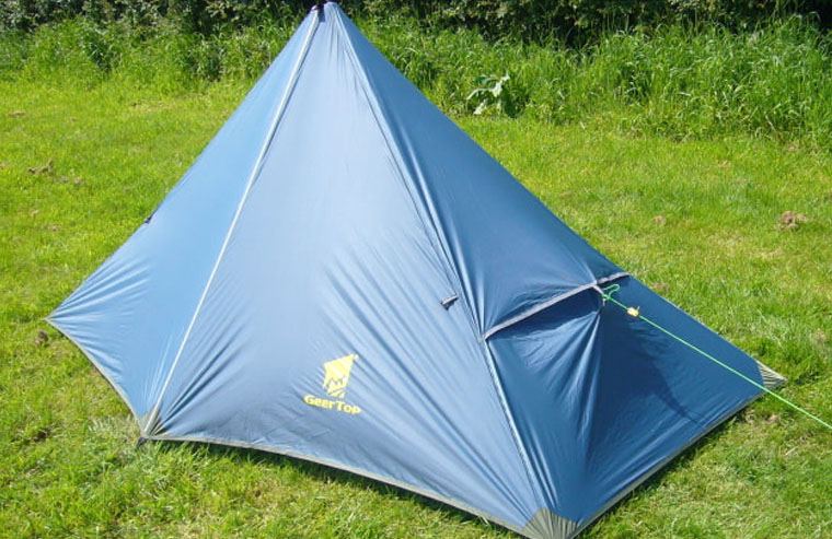 Blue tent pitched on the grass