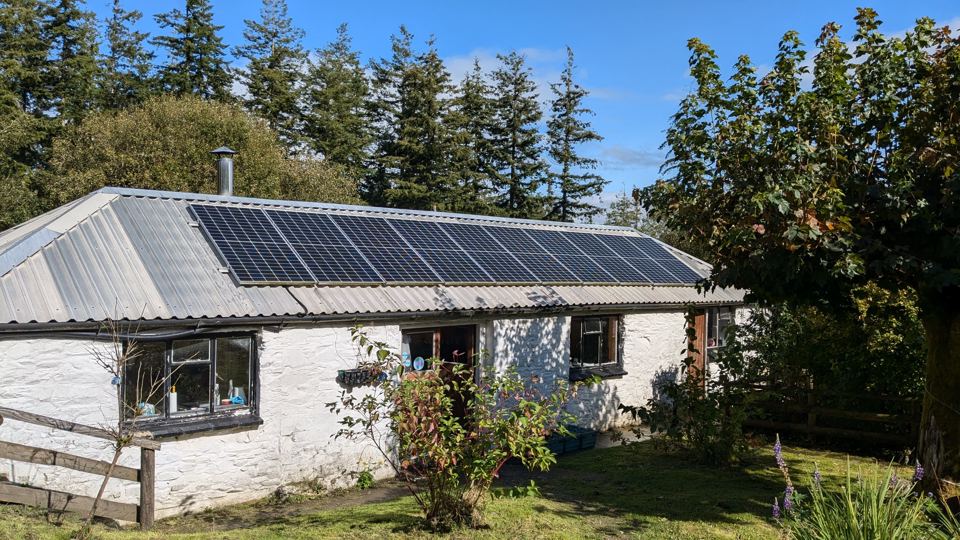 White-walled cottage with solar roof