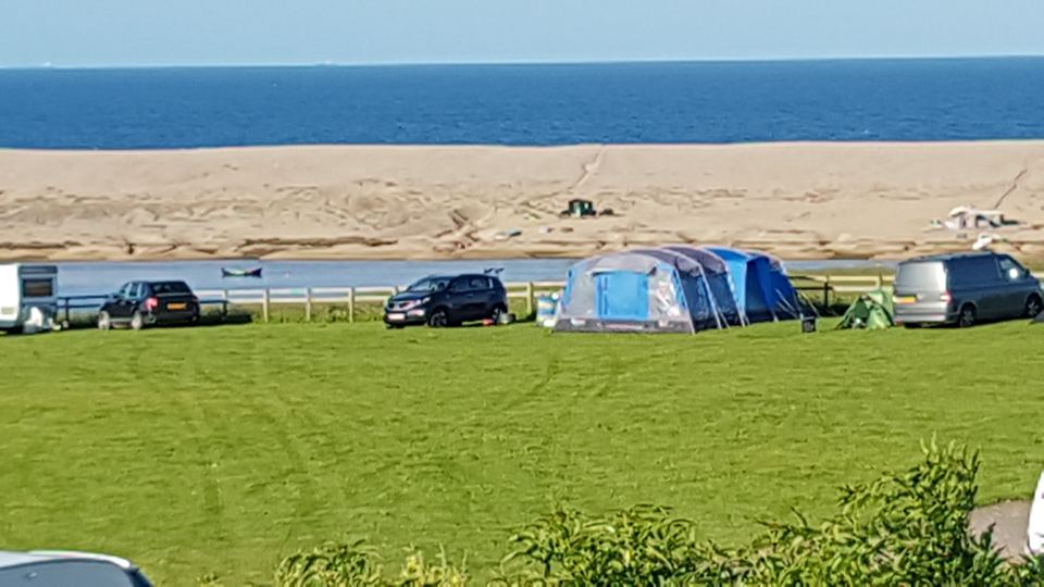 Tents and vans above the lagoon