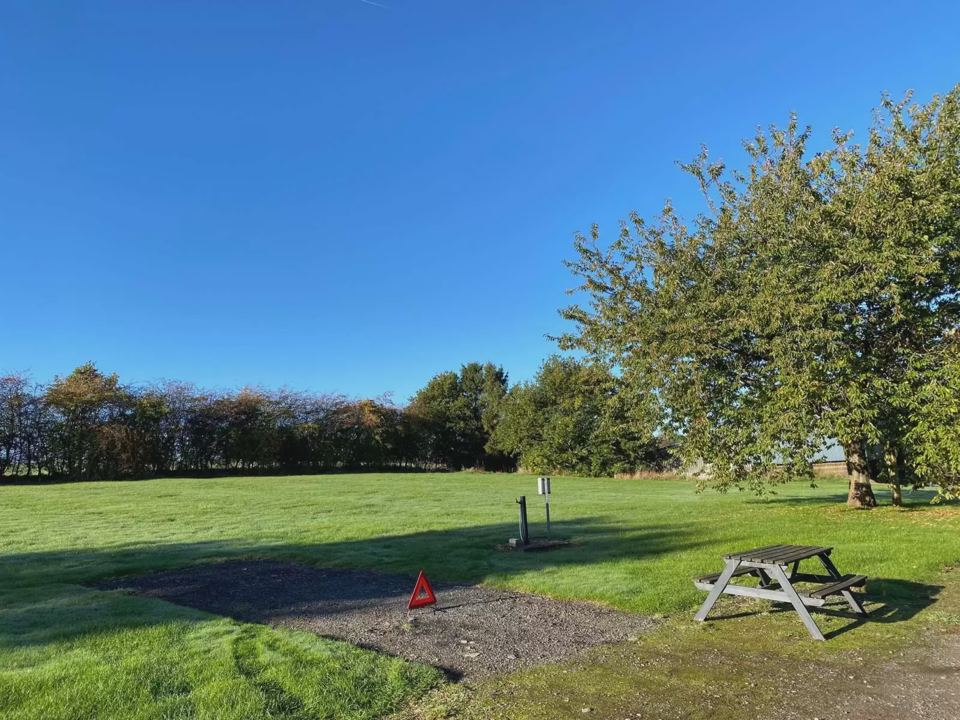 Grass pitch with picnic bench
