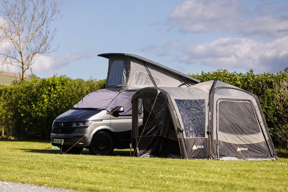 Campervan with awning on grass