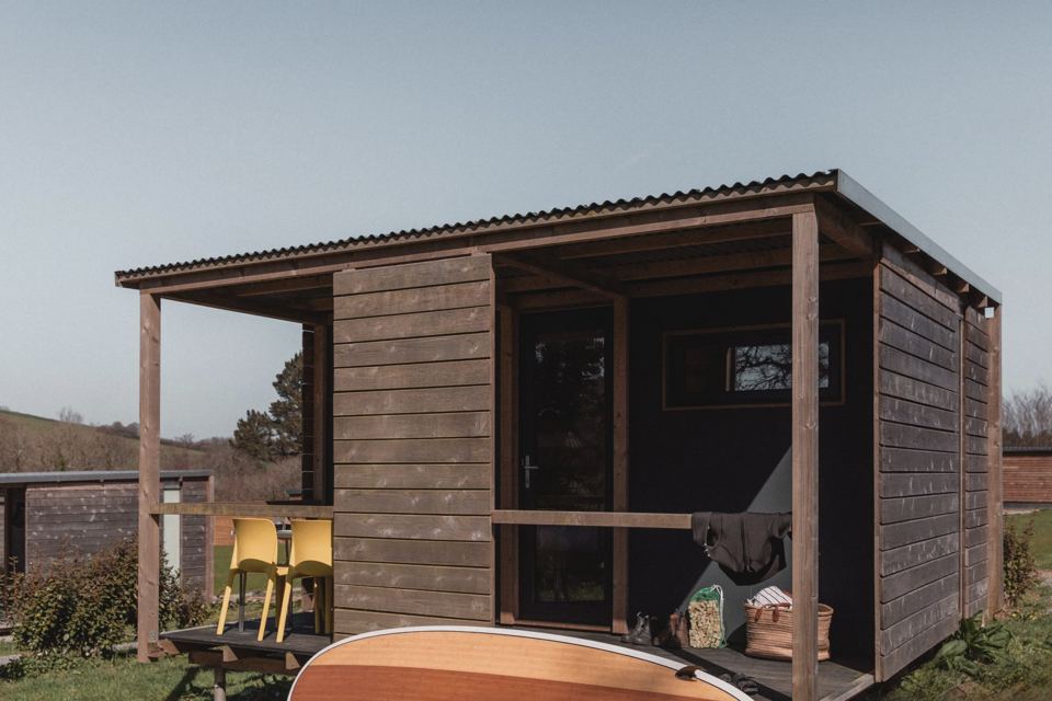 Wooden cabin with porch and canoe