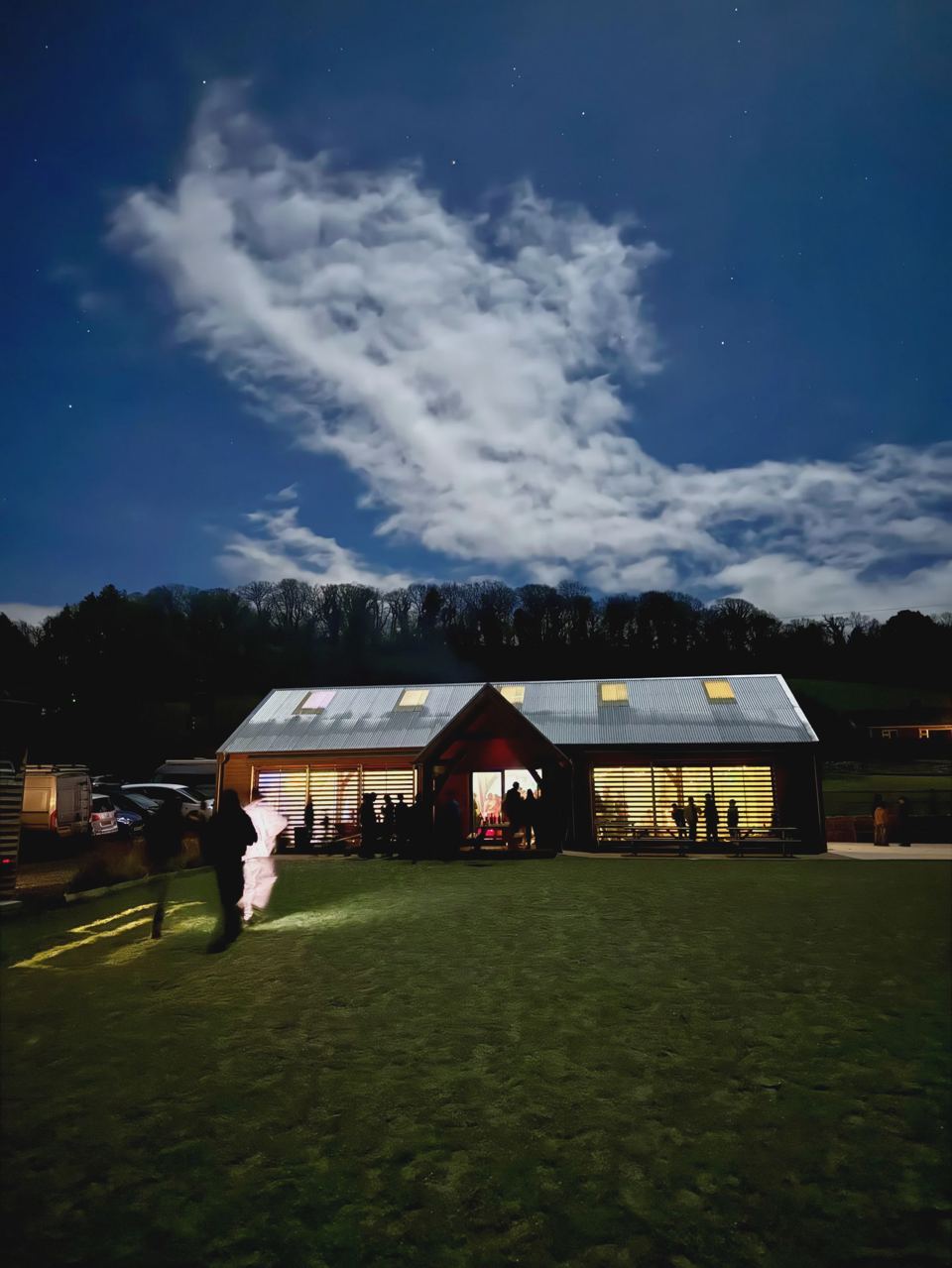 Lit barn accommodation at dusk
