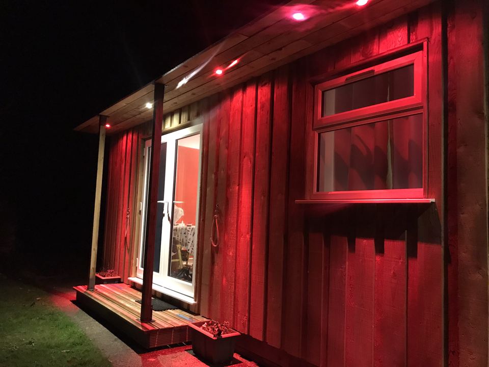 Wooden cabin lit up at night
