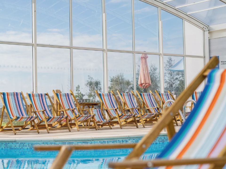 Indoor pool with deck chairs