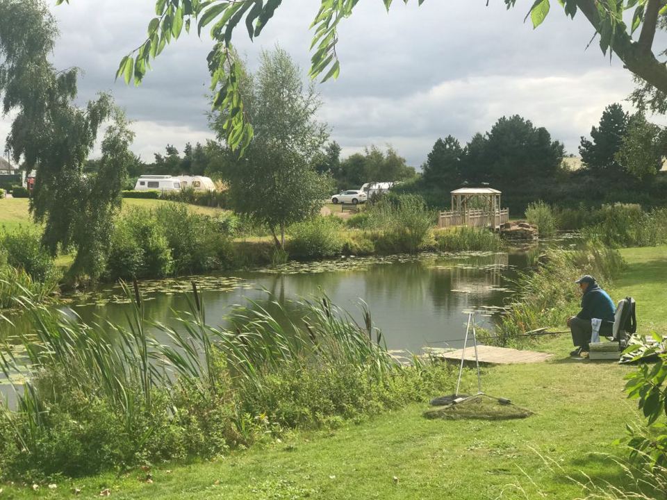 Lake with pitches behind