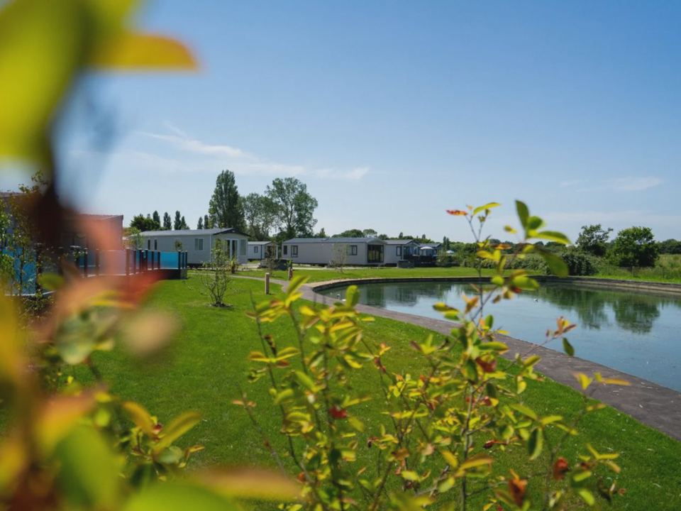 Lake with holiday homes behind