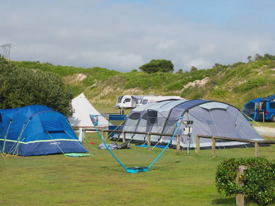 Tents with hills behind