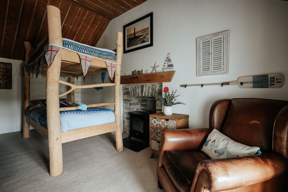 Bunk room with armchair